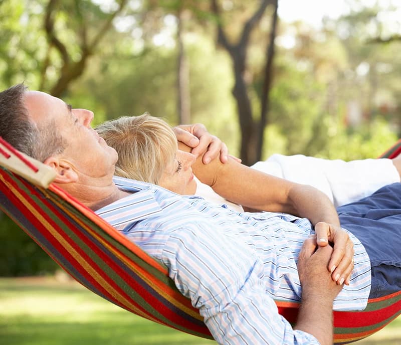 Man and woman resting in a hammock