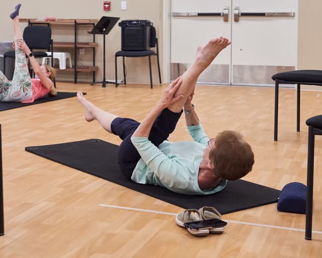 Woman stretching on yoga mat