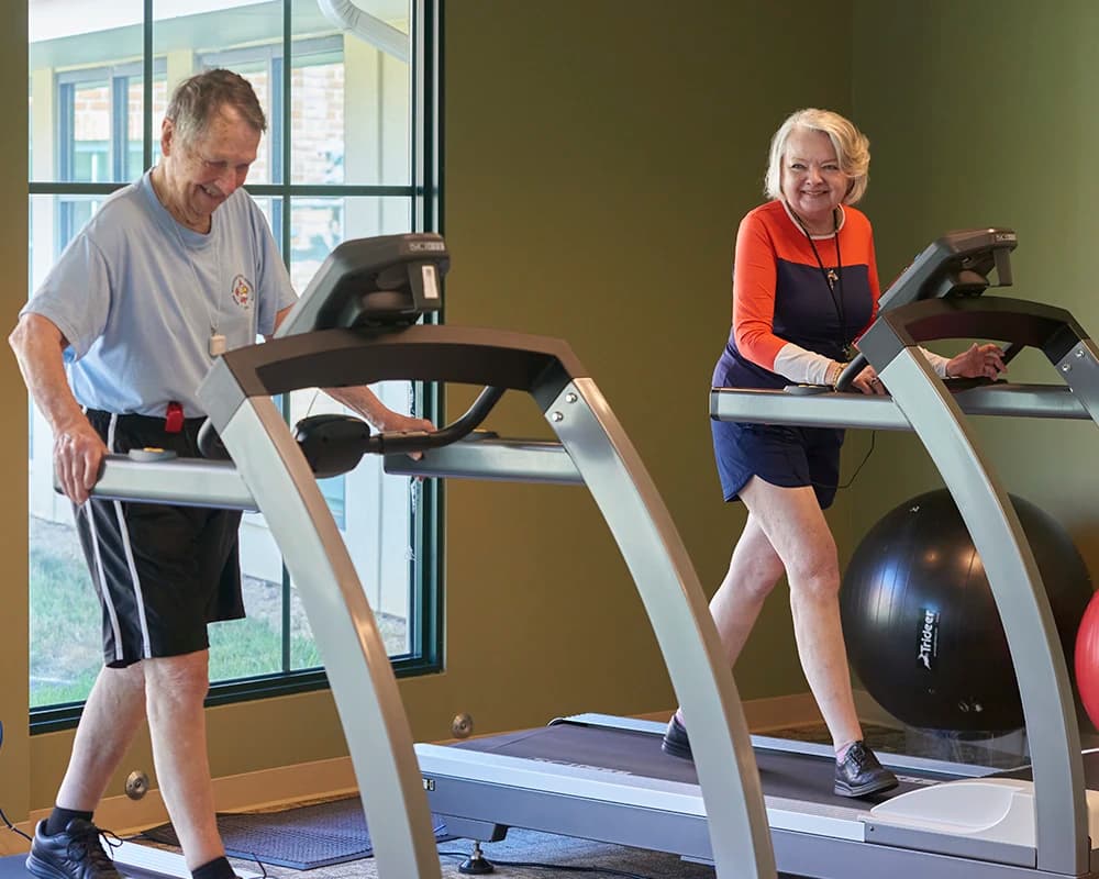 Man and woman using treadmills