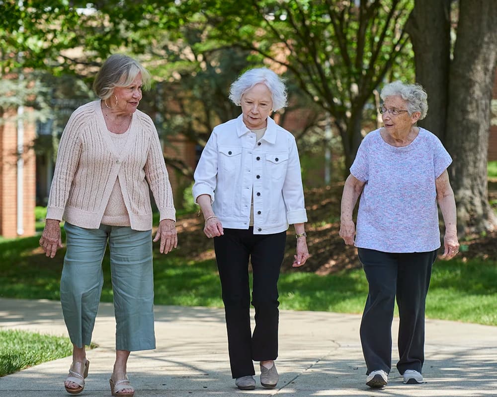 Three women walking outdoors in conversation