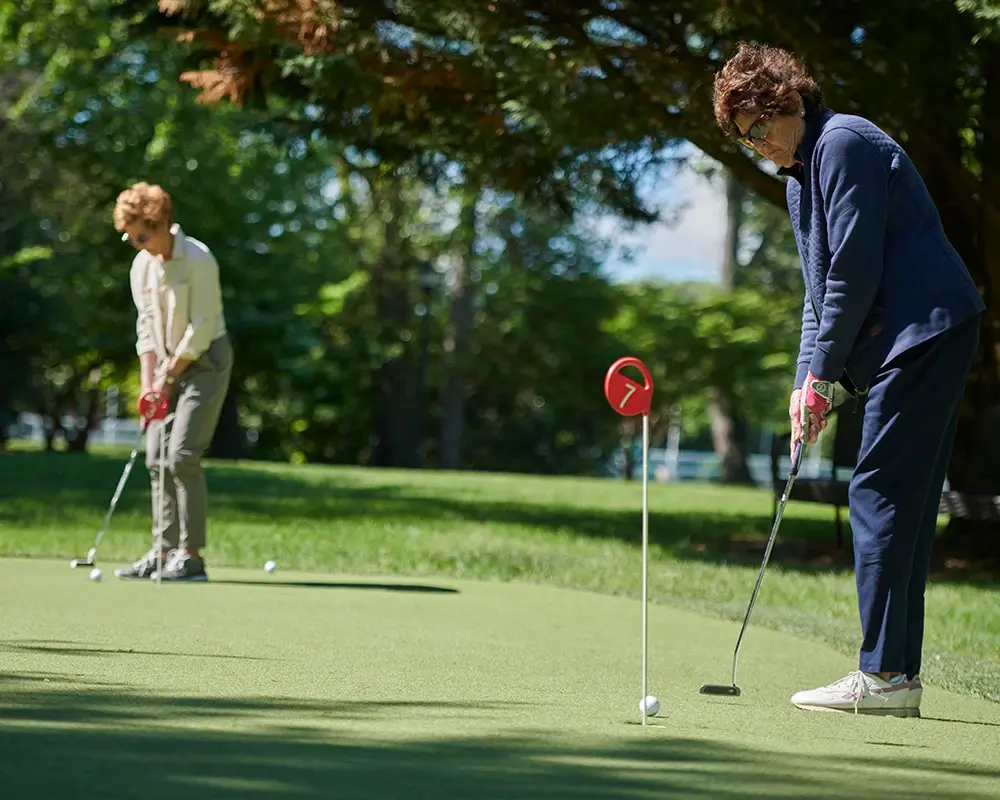 Two women practicing golf