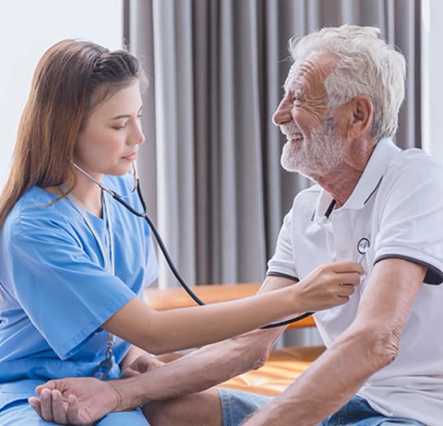 Care giver checking mans heart beat