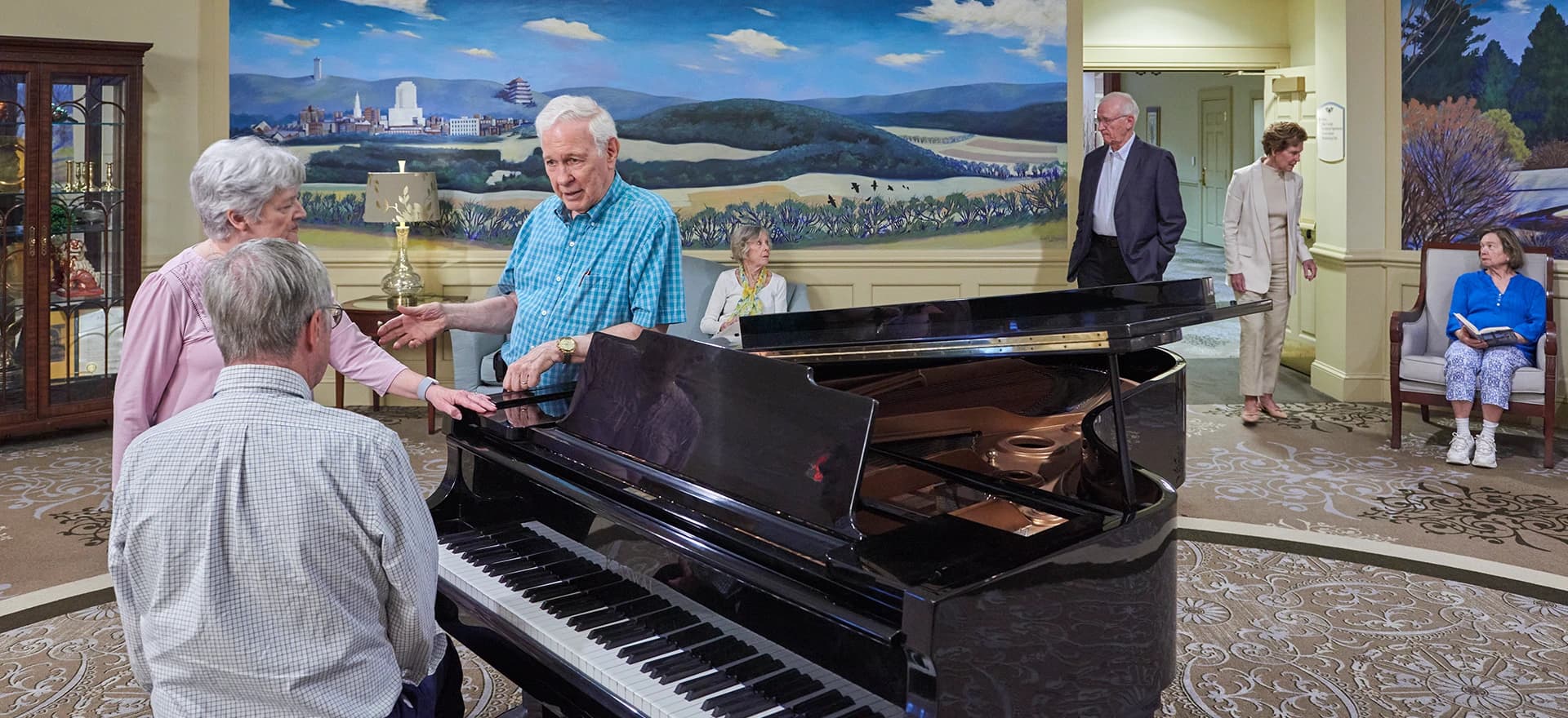 Residents in conversation next to a piano